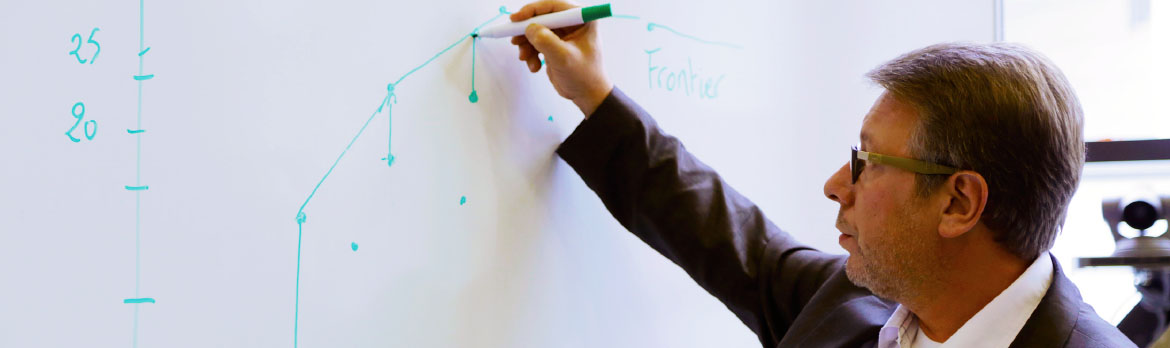 Professor writing on a whiteboard